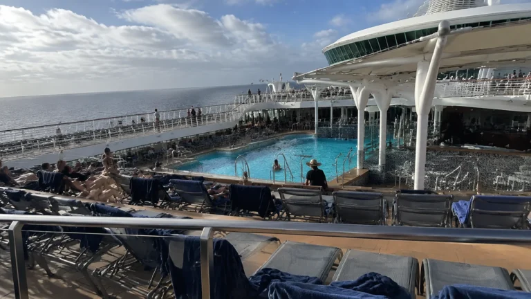 Cruise ship pool deck with rows of lounge chairs
