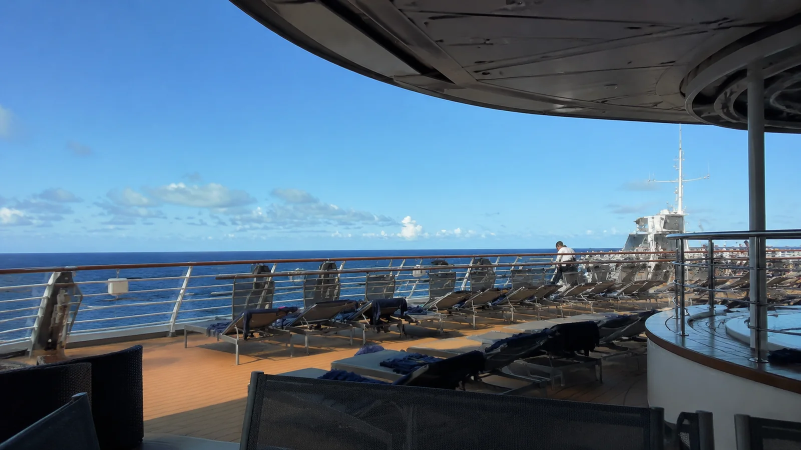 Empty lido deck with lounge chairs overlooking the ocean
