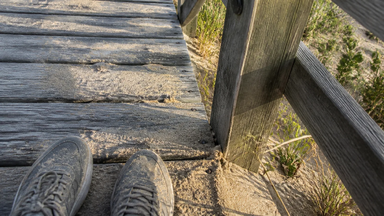 Hiking shoes on a weathered wooden boardwalk