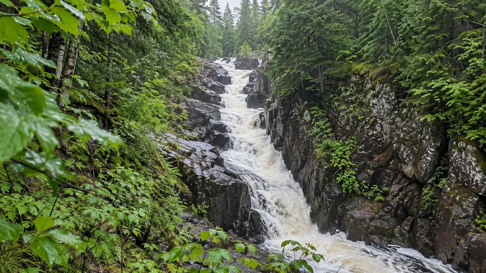 Long Slide Falls descends through a narrow rocky gorge in Marinette County.