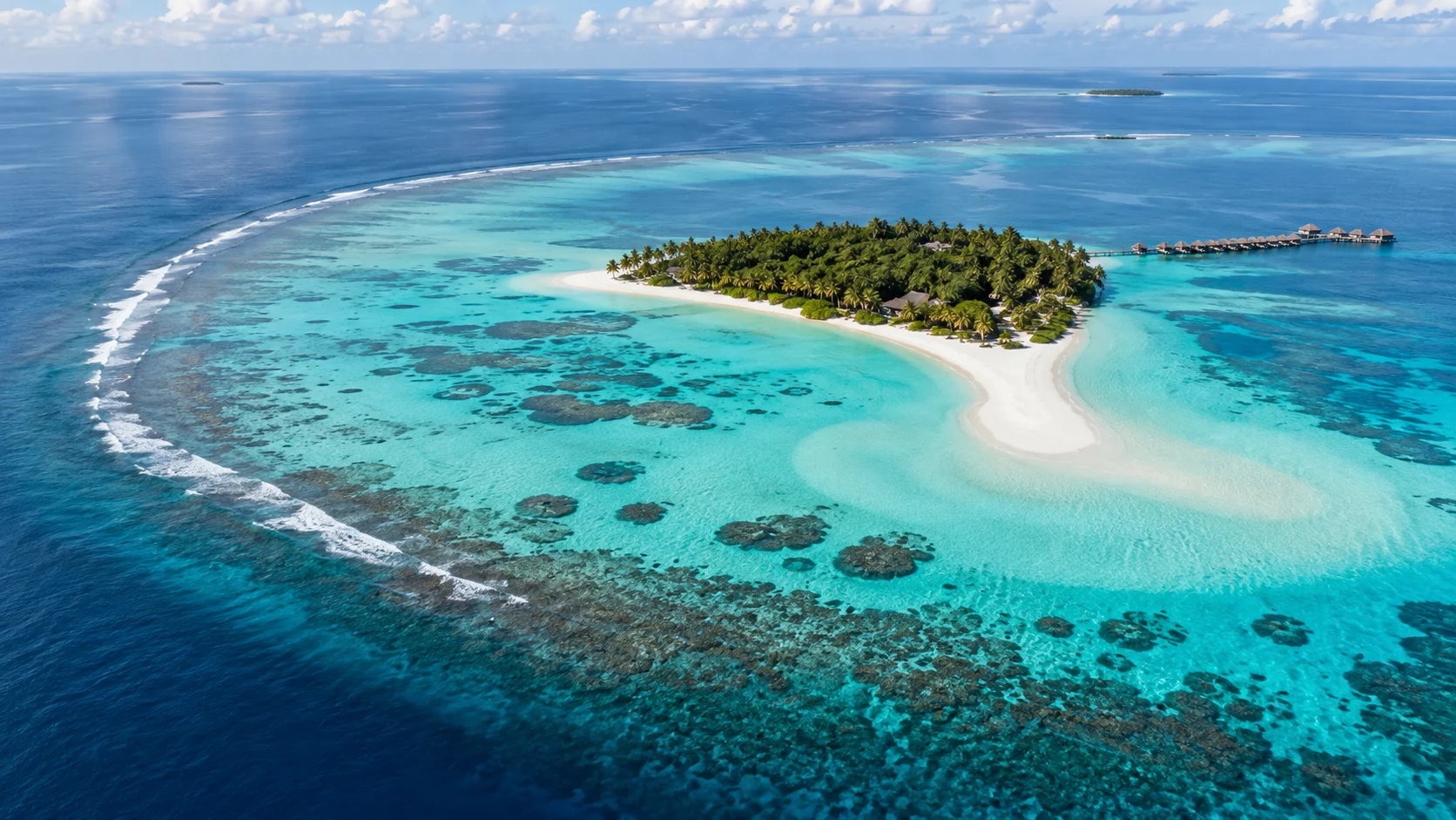 A white sand island and turquoise coral lagoon in the Maldives.