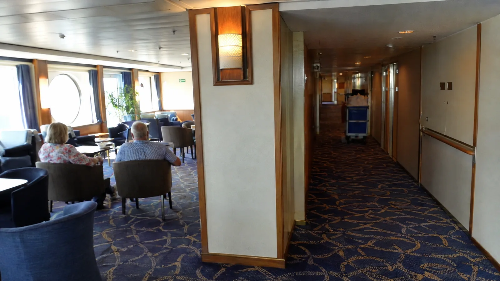 Ship lounge opening directly onto a cabin corridor.