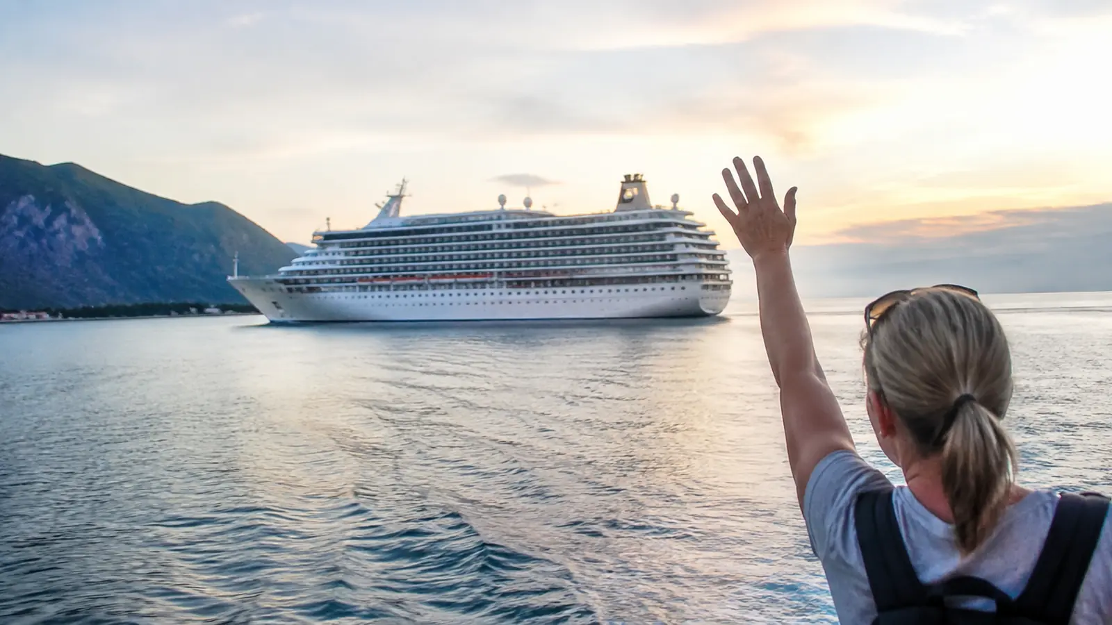 Cruise ship leaving port as passengers return from shore