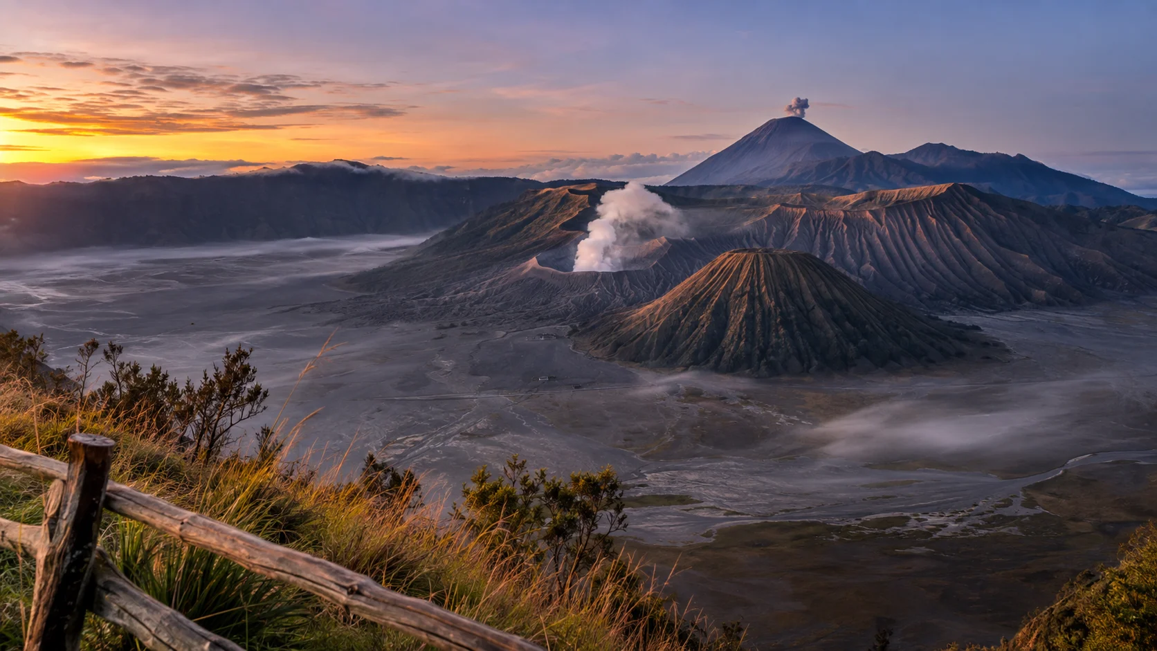 Smoking Mount Bromo, ridged Mount Batok, and distant Semeru fill the Tengger caldera at dawn.
