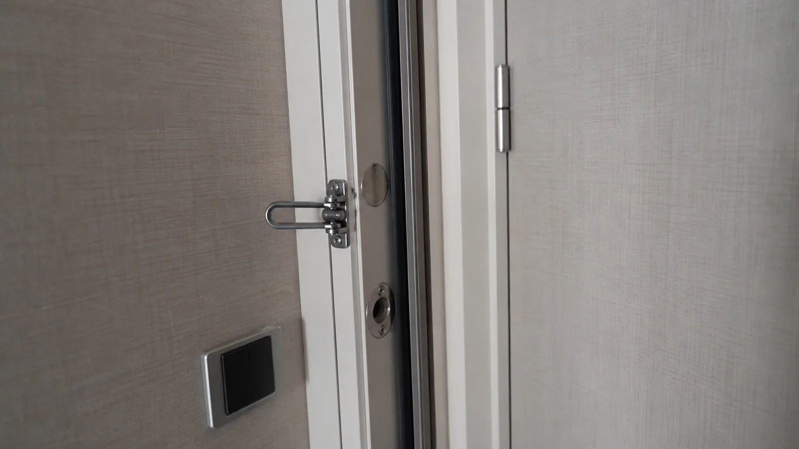 Close-up of a security latch on a connecting cruise cabin door