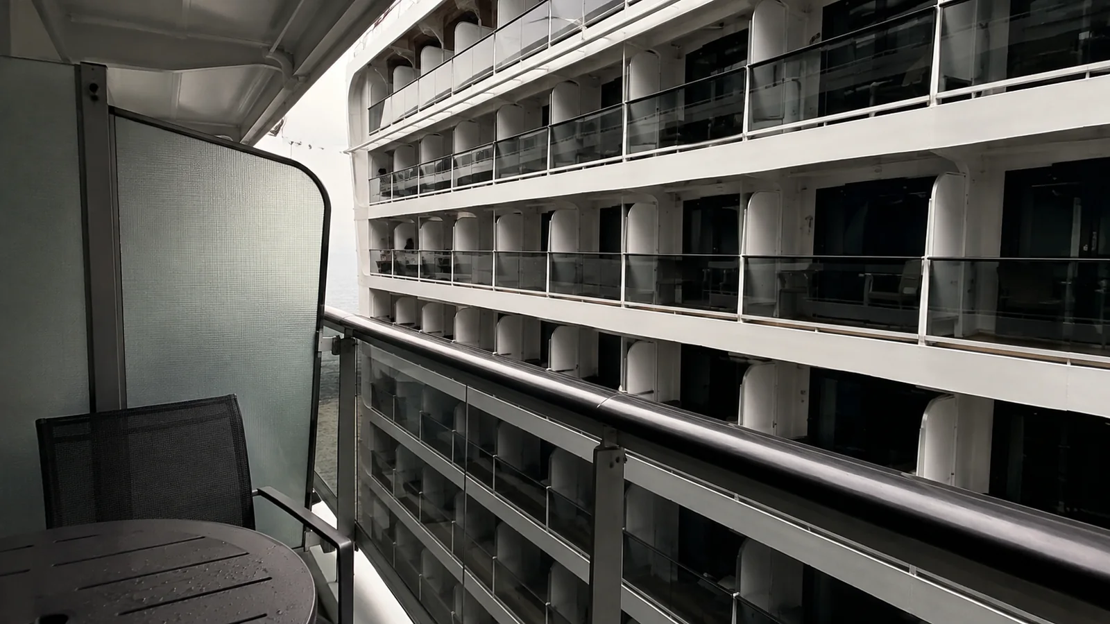 Balcony faces multiple rows of other balconies across a ship courtyard.