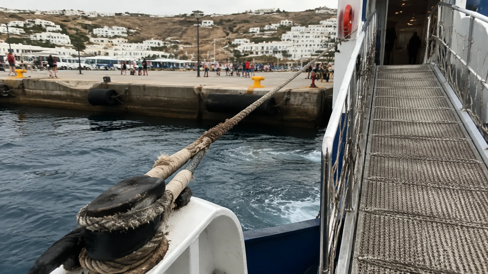 Ship's gangway and mooring rope beside a harbor quay