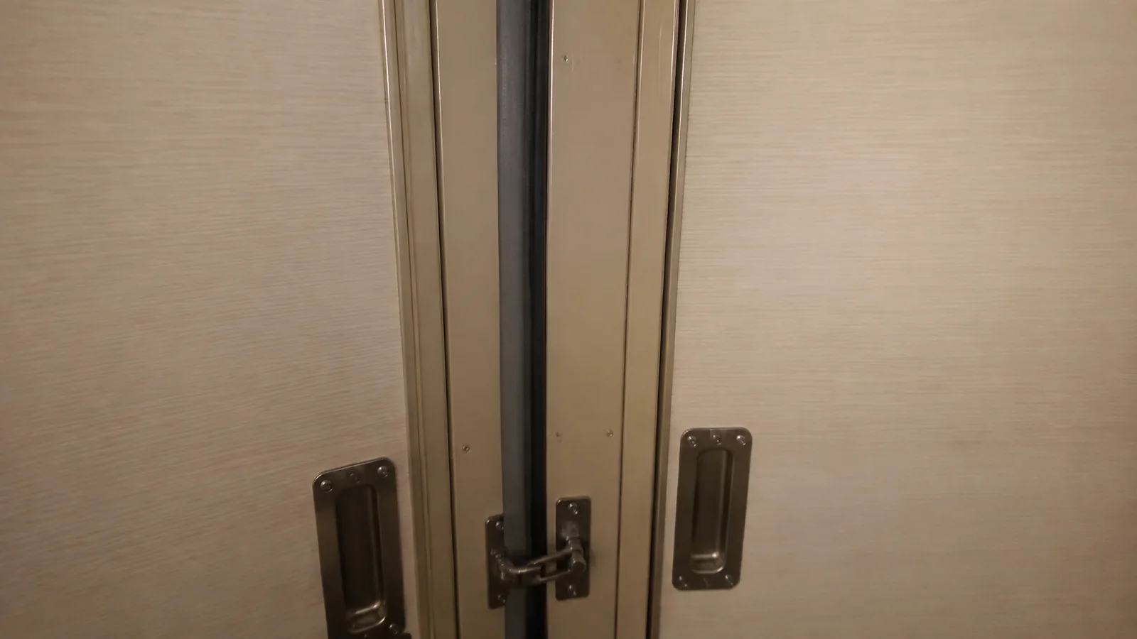 Close view of adjoining cabin doors and their handles.