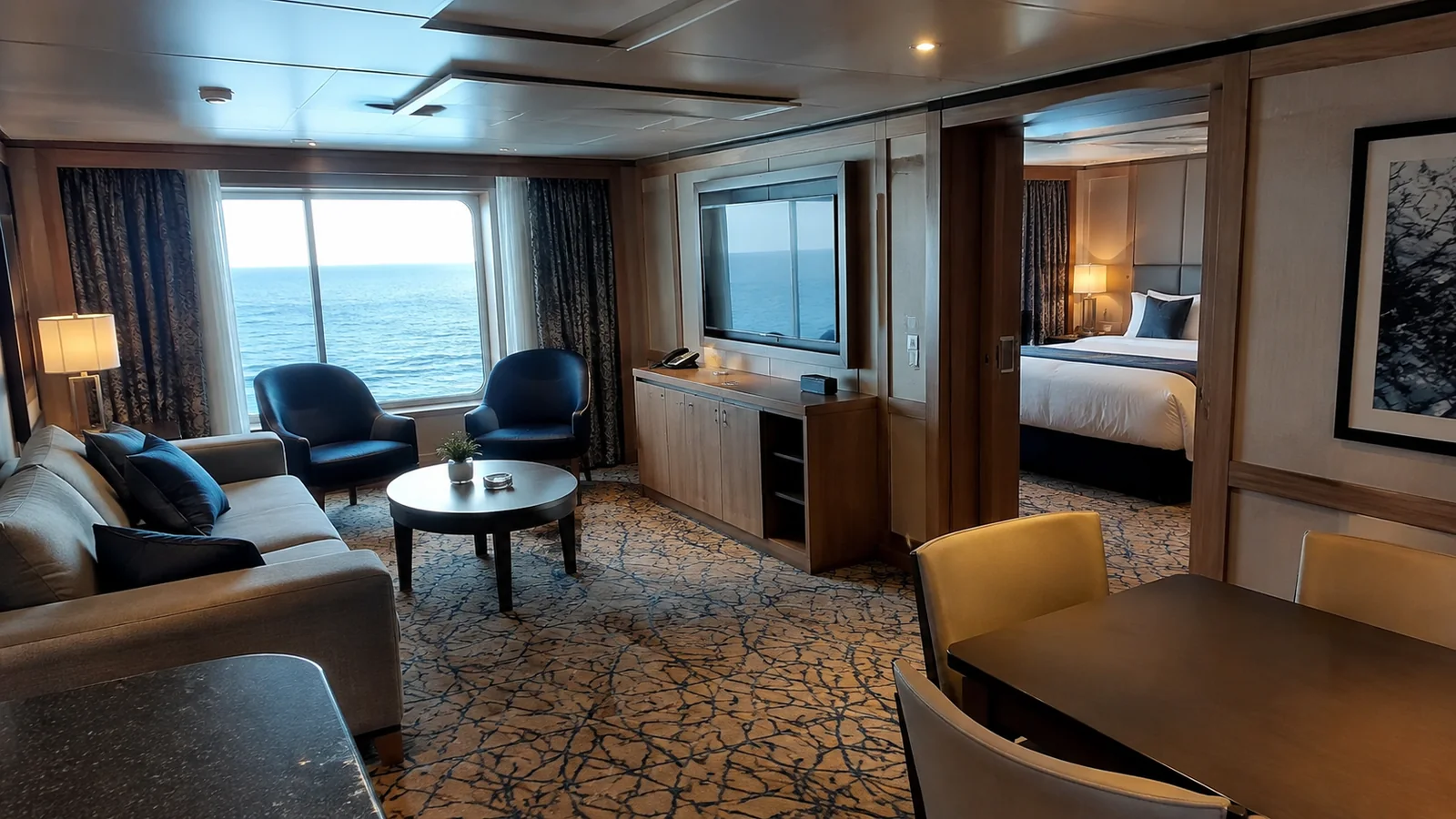 Suite sitting room contains a sofa, armchairs and a separate bedroom doorway.