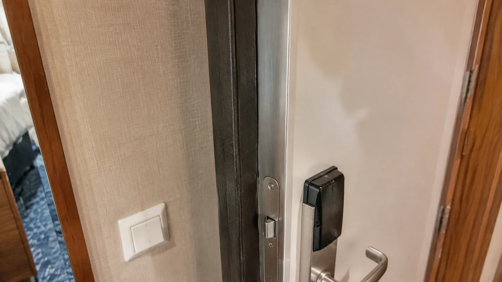 Close-up of an electronic lock and handle on a cruise cabin door