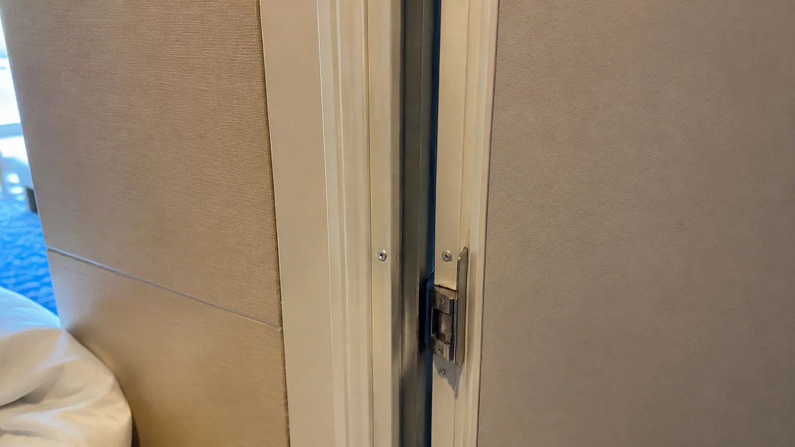 Close-up of a partially open connecting door inside a cruise cabin