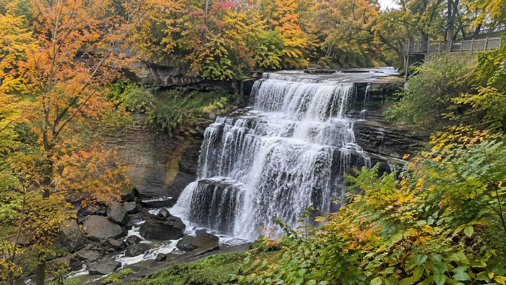 Brandywine Falls cascading through autumn forest in Cuyahoga Valley National Park.
