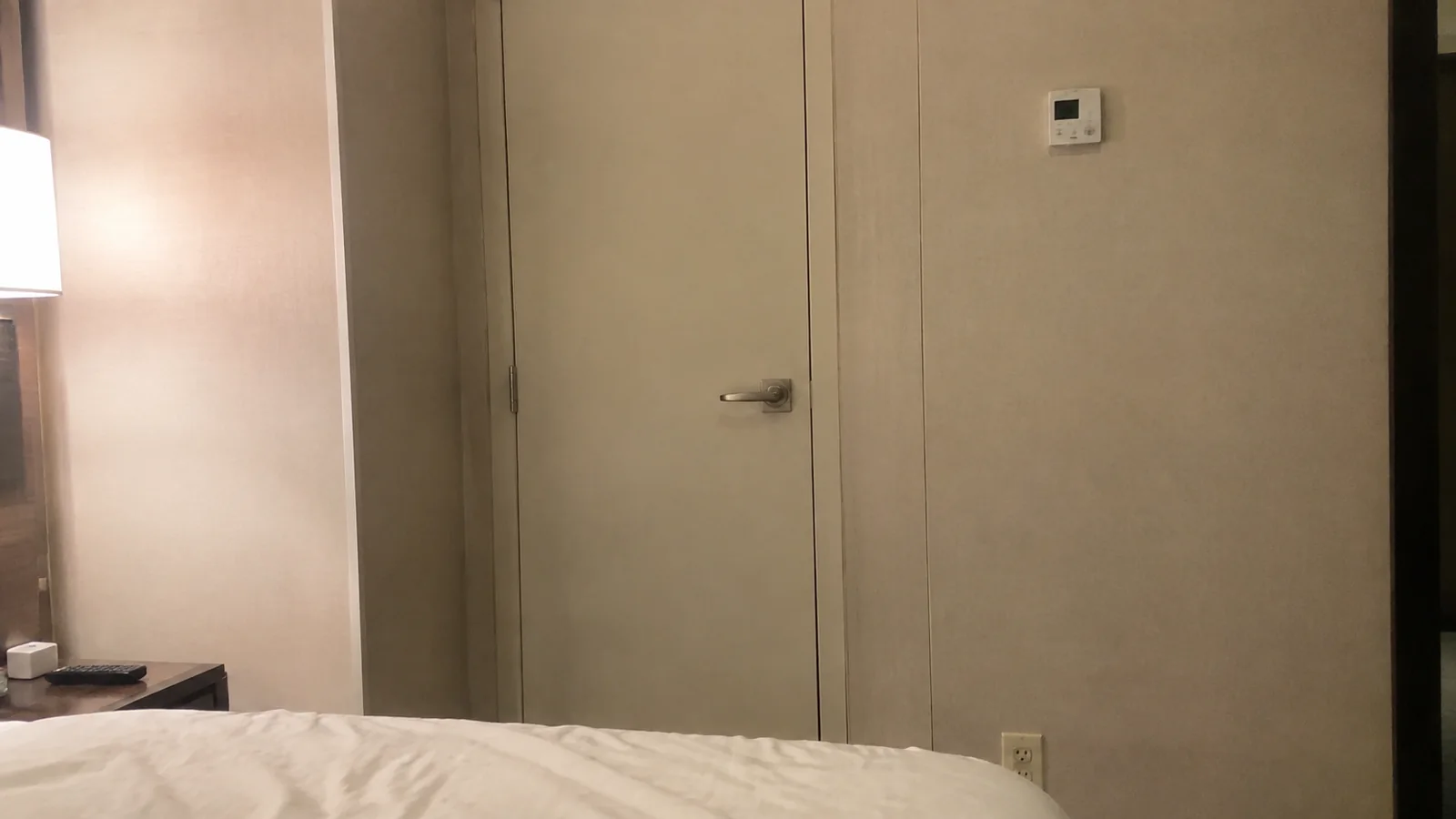 Closed connecting door in the wall beside a cabin bed.