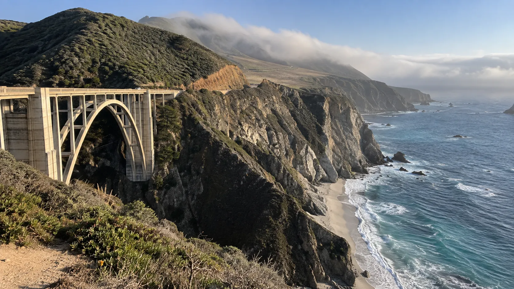 Bixby Creek Bridge spanning a steep canyon above the rugged Big Sur coastline.