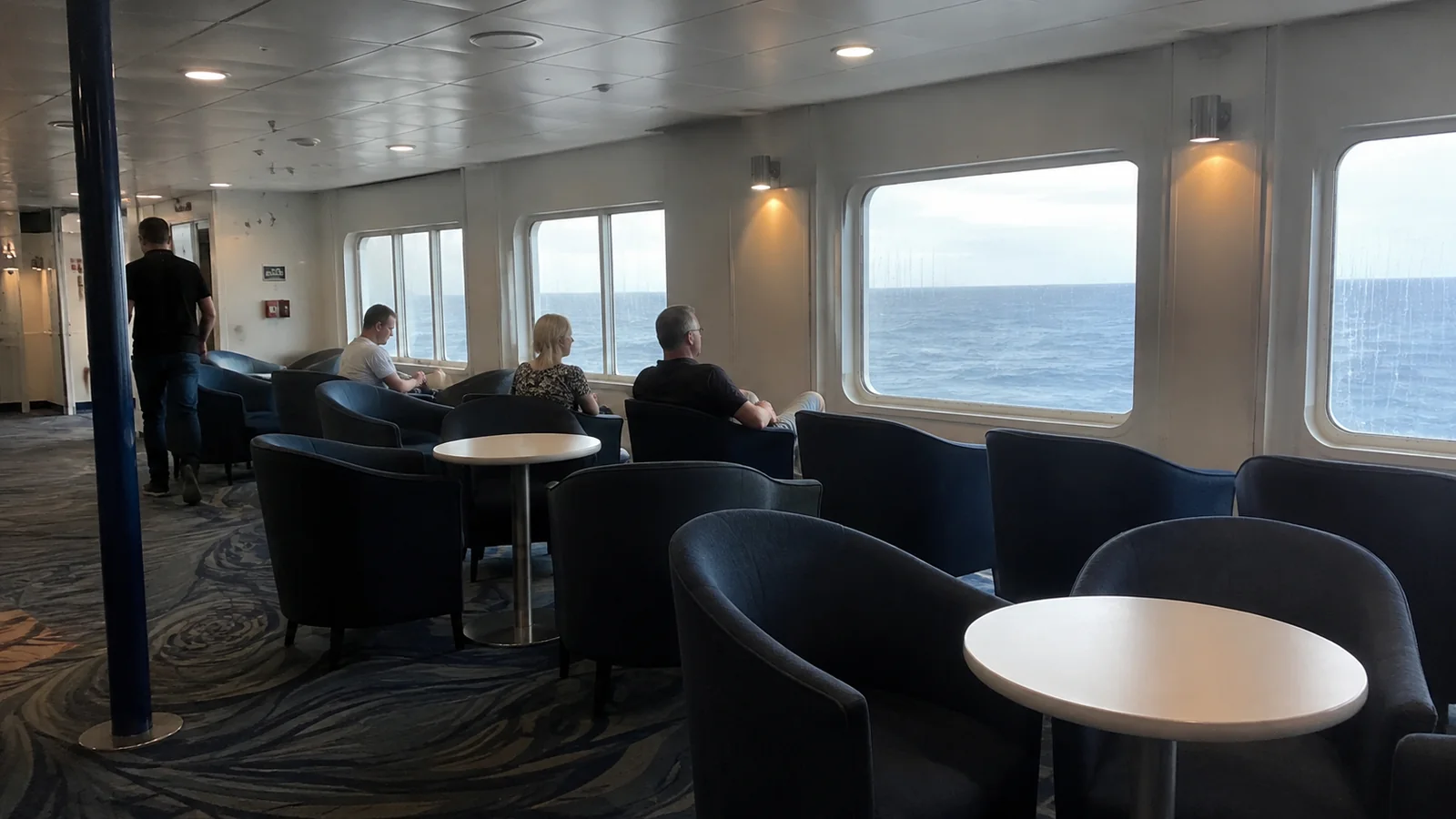 Quiet ocean-view lounge with armchairs and small tables.