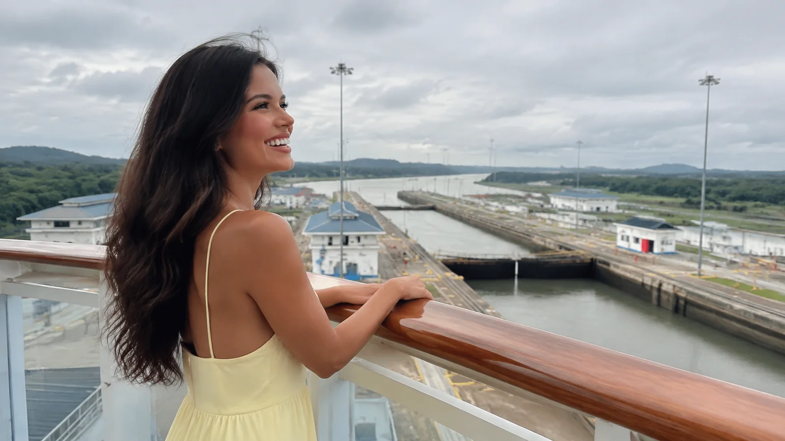 Woman leaning on a ship railing overlooking canal locks.
