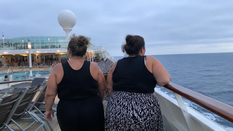 Two women walking on a cruise ship deck