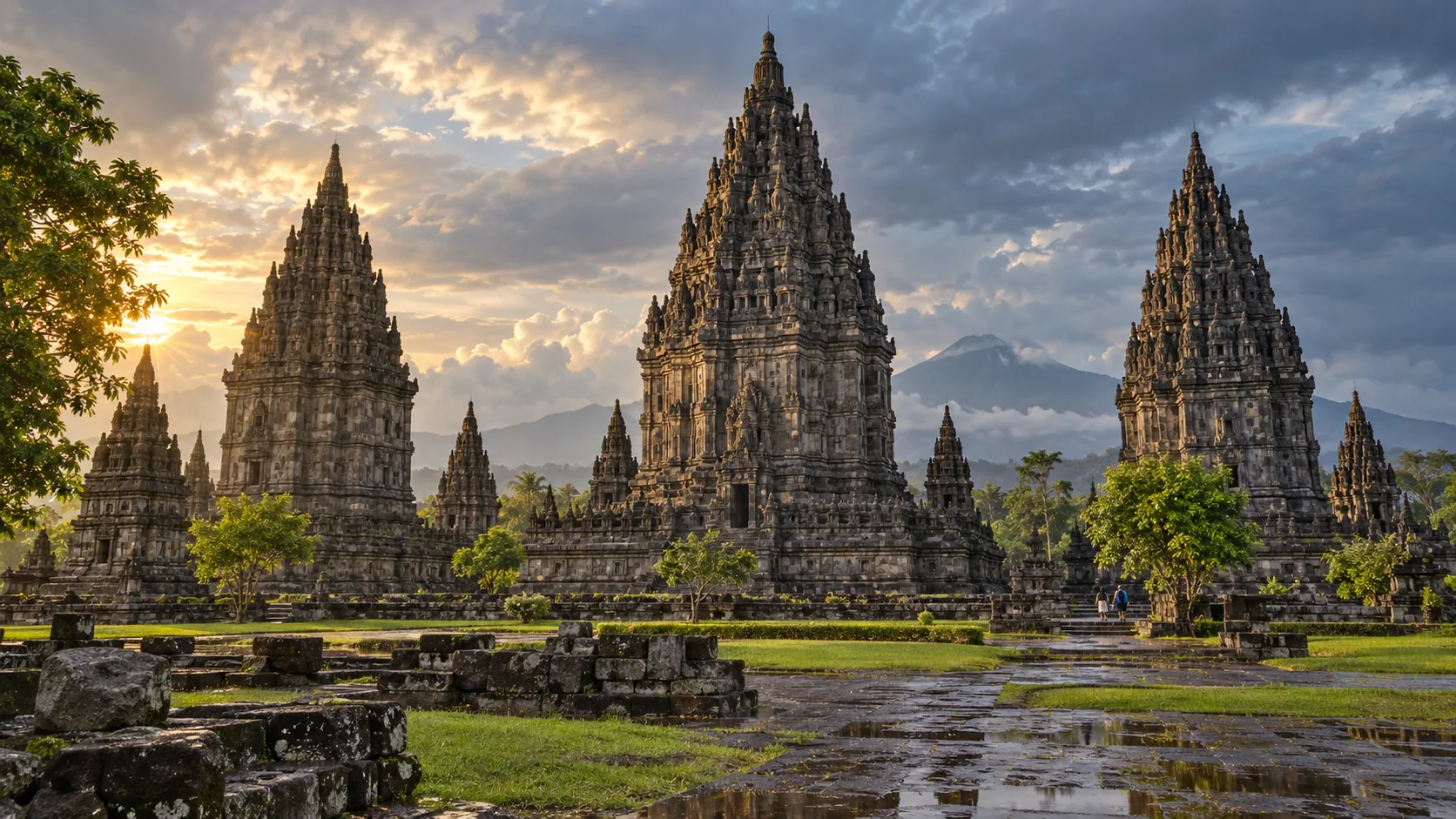 Prambanan's towering Hindu temple spires glow beneath storm-clearing skies near Yogyakarta.