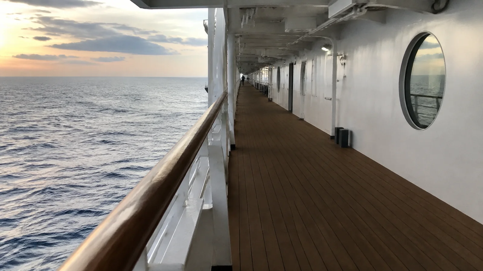 Empty cruise ship promenade deck at sunset