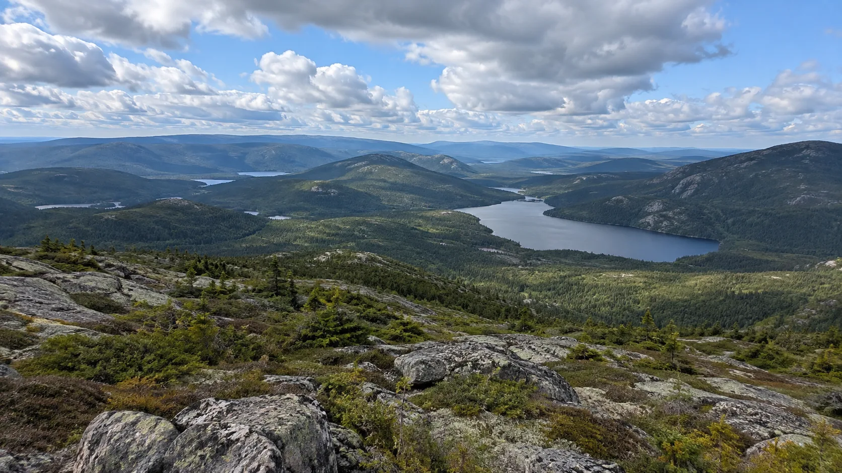 Rocky summit overlooking boreal lakes and rolling terrain in Grands-Jardins National Park.