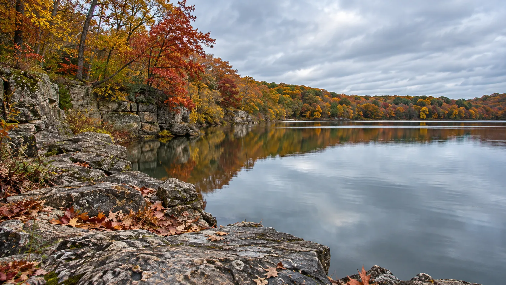 A rocky lakeshore and colorful fall forest at Rock Cut State Park near Rockford.
