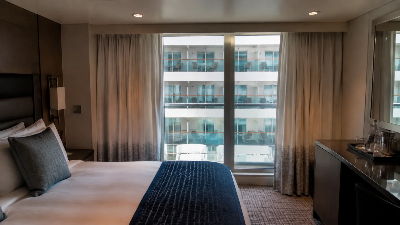Stateroom balcony doors face another row of ship balconies.