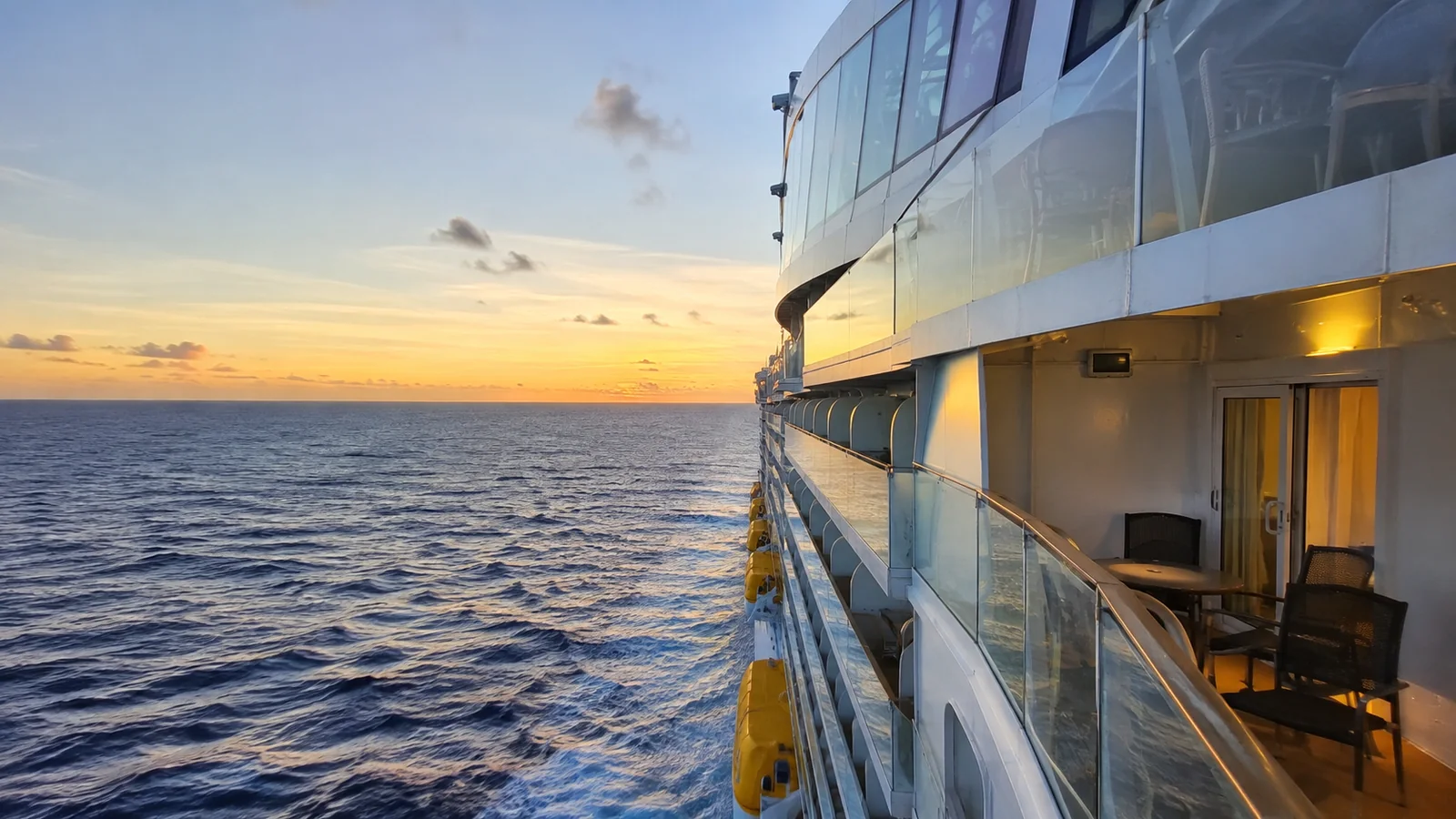 Cruise ship balcony and exterior decks overlooking the ocean at sunset