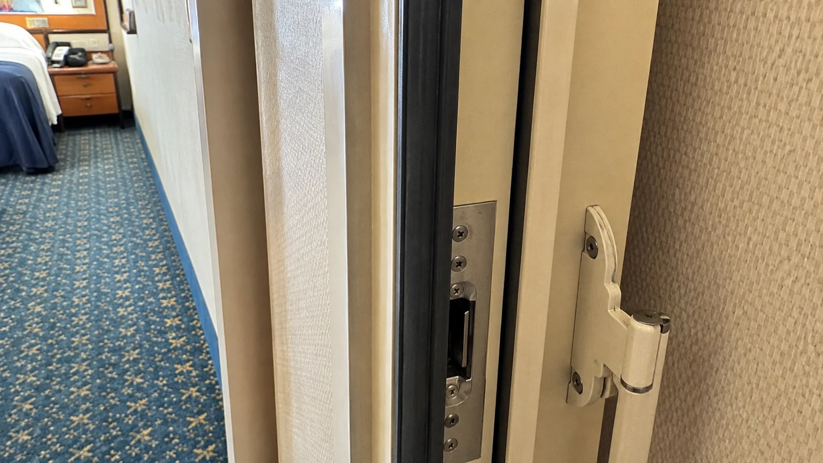Close-up of a connecting door latch between cruise cabins