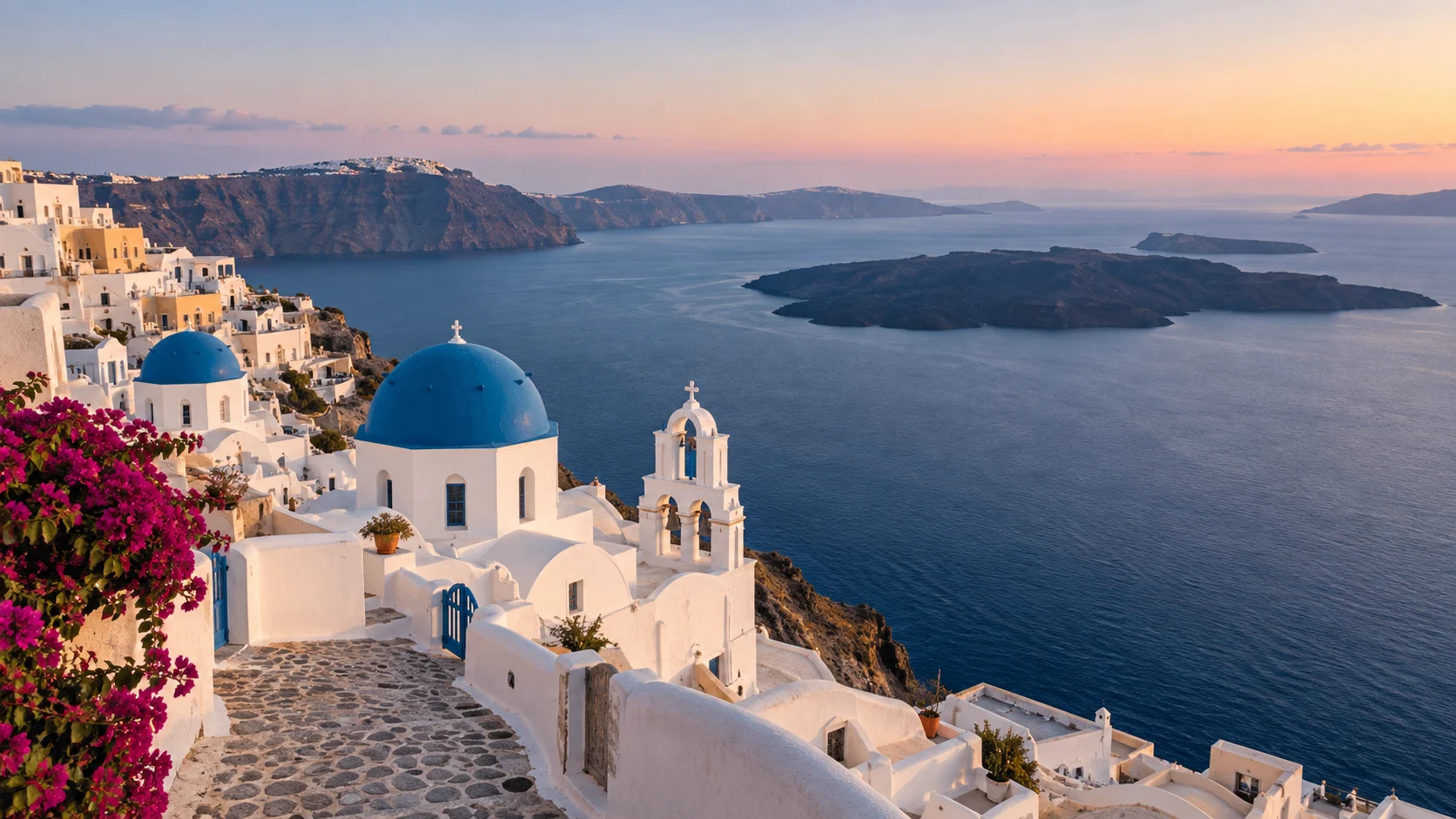 Whitewashed Oia and blue-domed churches overlooking Santorini's volcanic caldera.