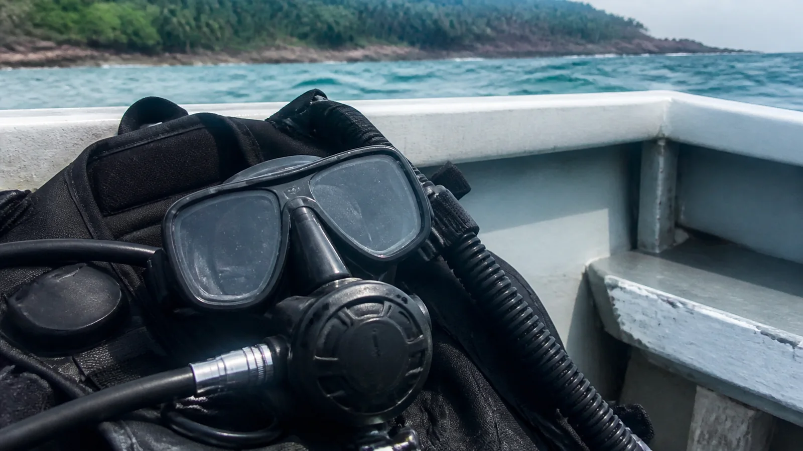 Scuba mask, regulator and buoyancy gear in a small boat.