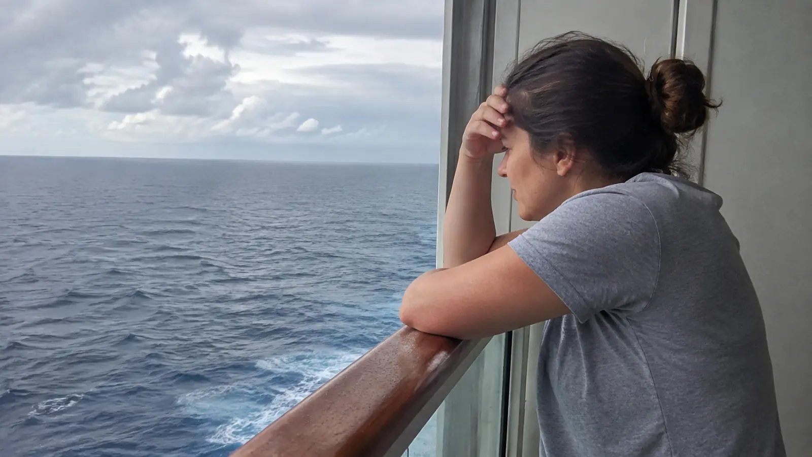 Cloudy ocean horizon and ship wake viewed from a cruise ship