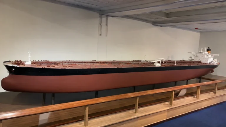 Long scale model of an oil tanker displayed in a museum.