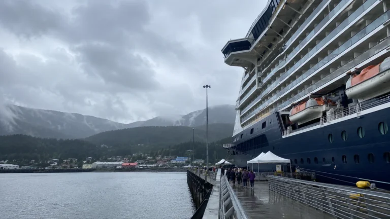 Cruise ship docked at a misty mountain port