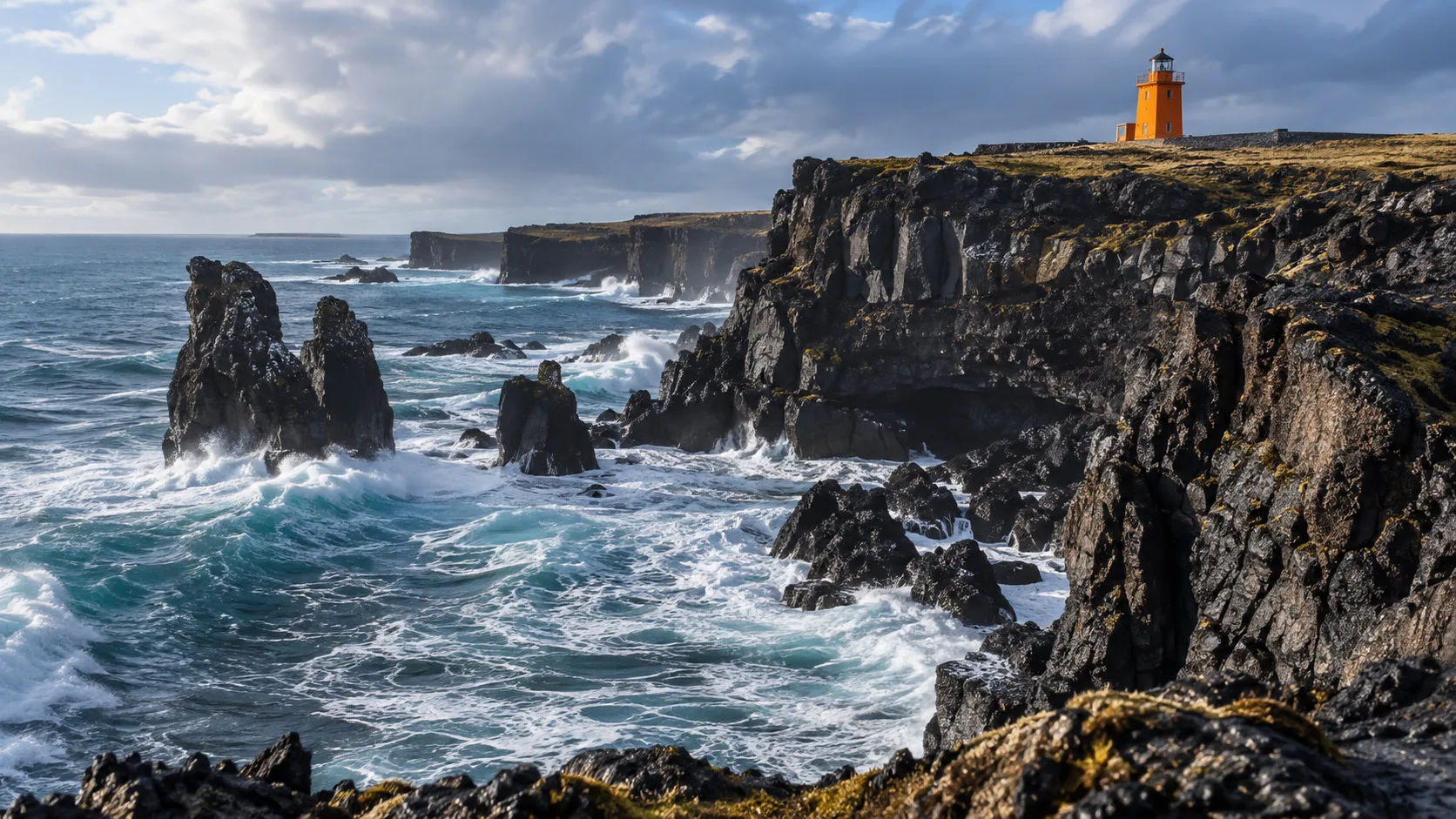 Orange Skálasnagi Lighthouse standing above the black Svörtuloft cliffs and foaming Atlantic surf.