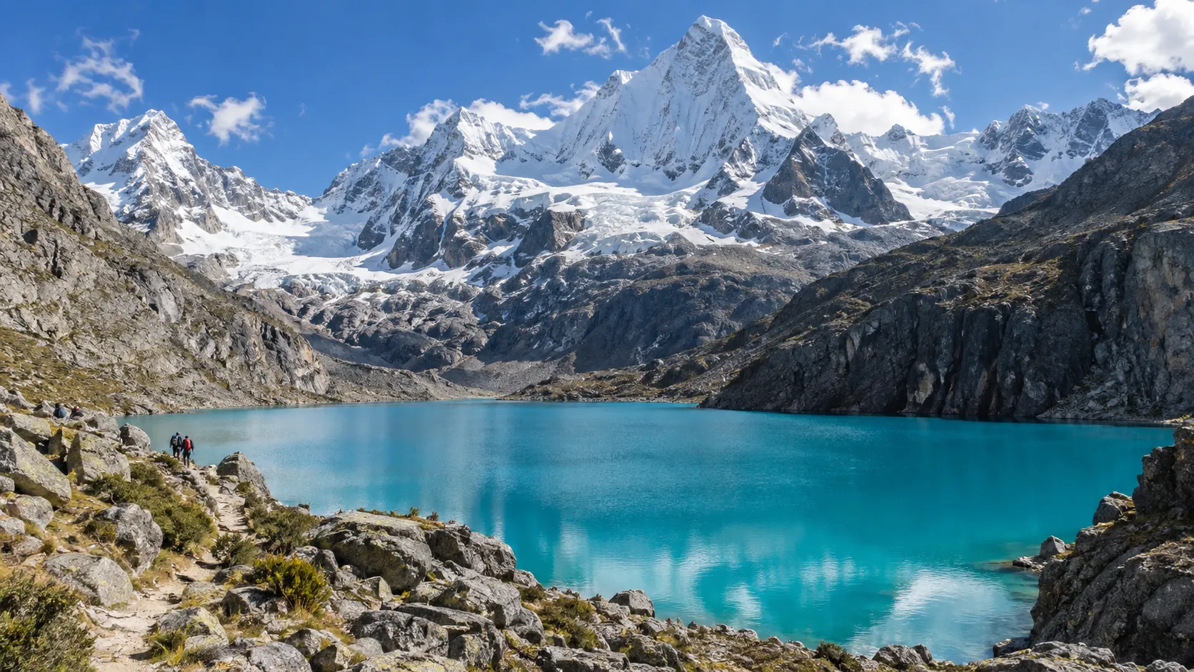 Turquoise alpine lake and snowy Cordillera Blanca peaks near Huaraz, Peru