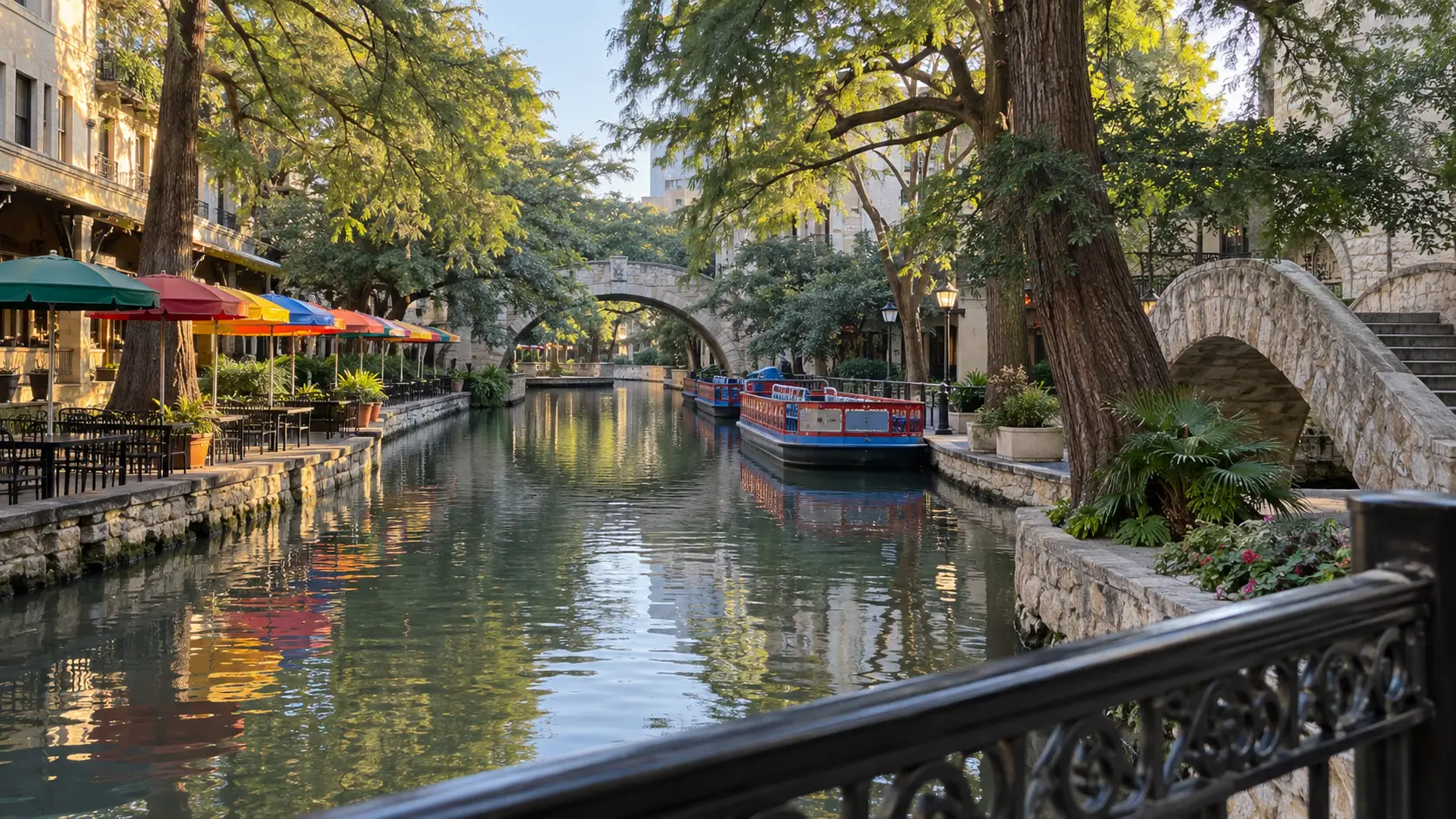 Stone bridges, cypress trees, and boats along the San Antonio River Walk