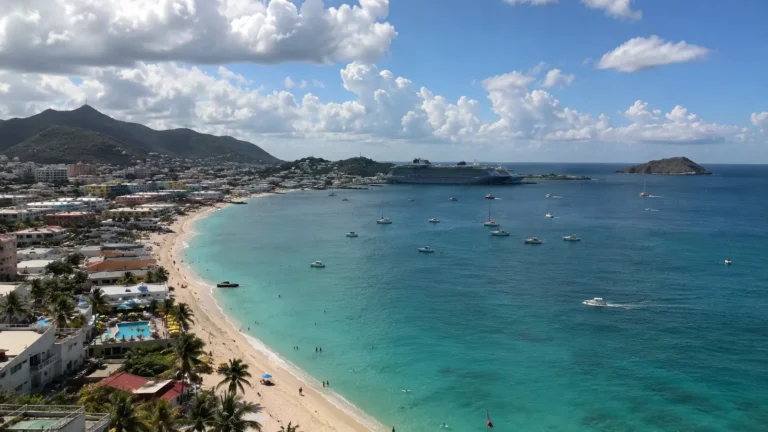 Aerial view of a turquoise bay, beach, and coastal town