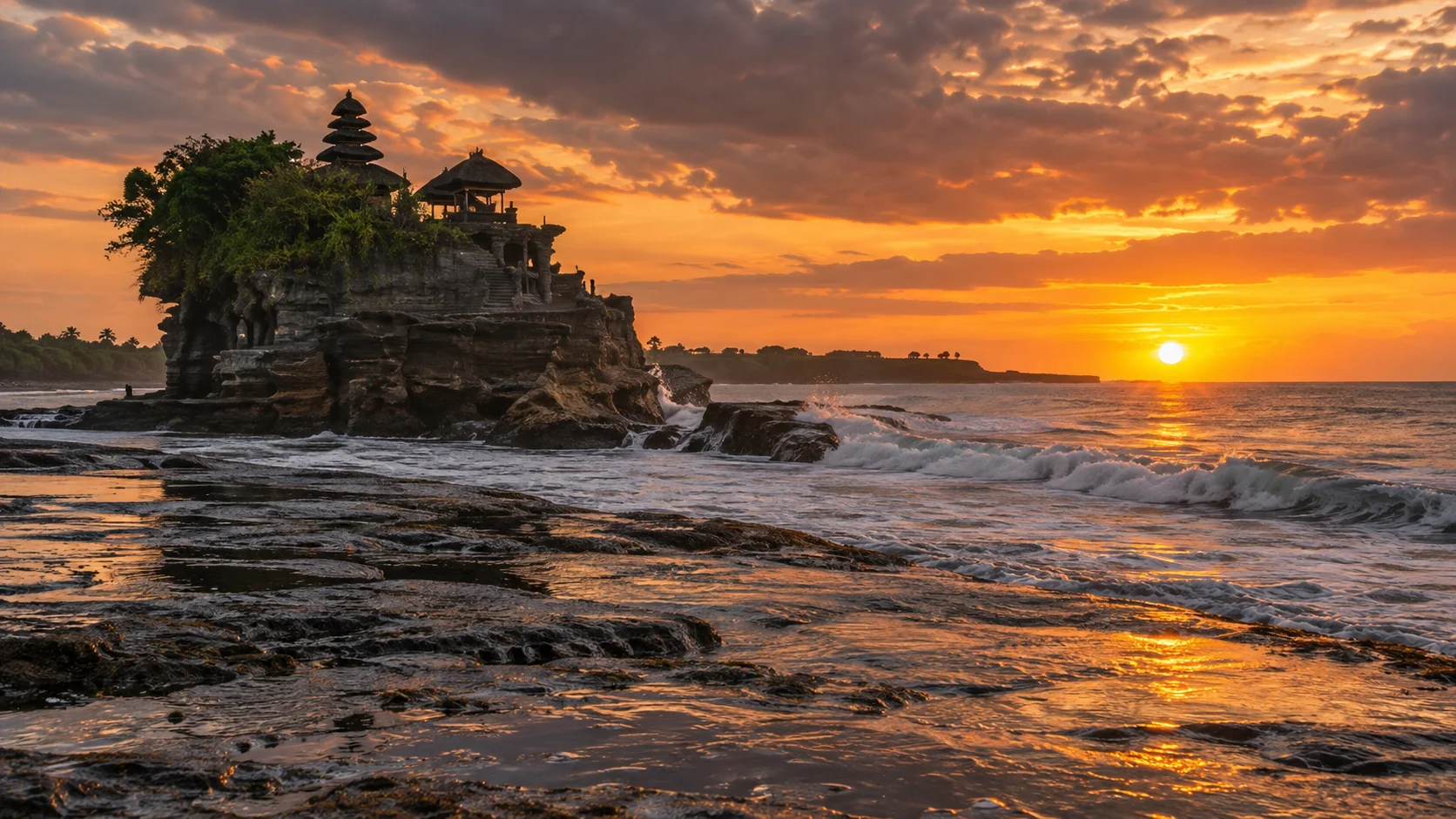 Tanah Lot sea temple rises above black volcanic rock and glowing sunset surf in Bali.