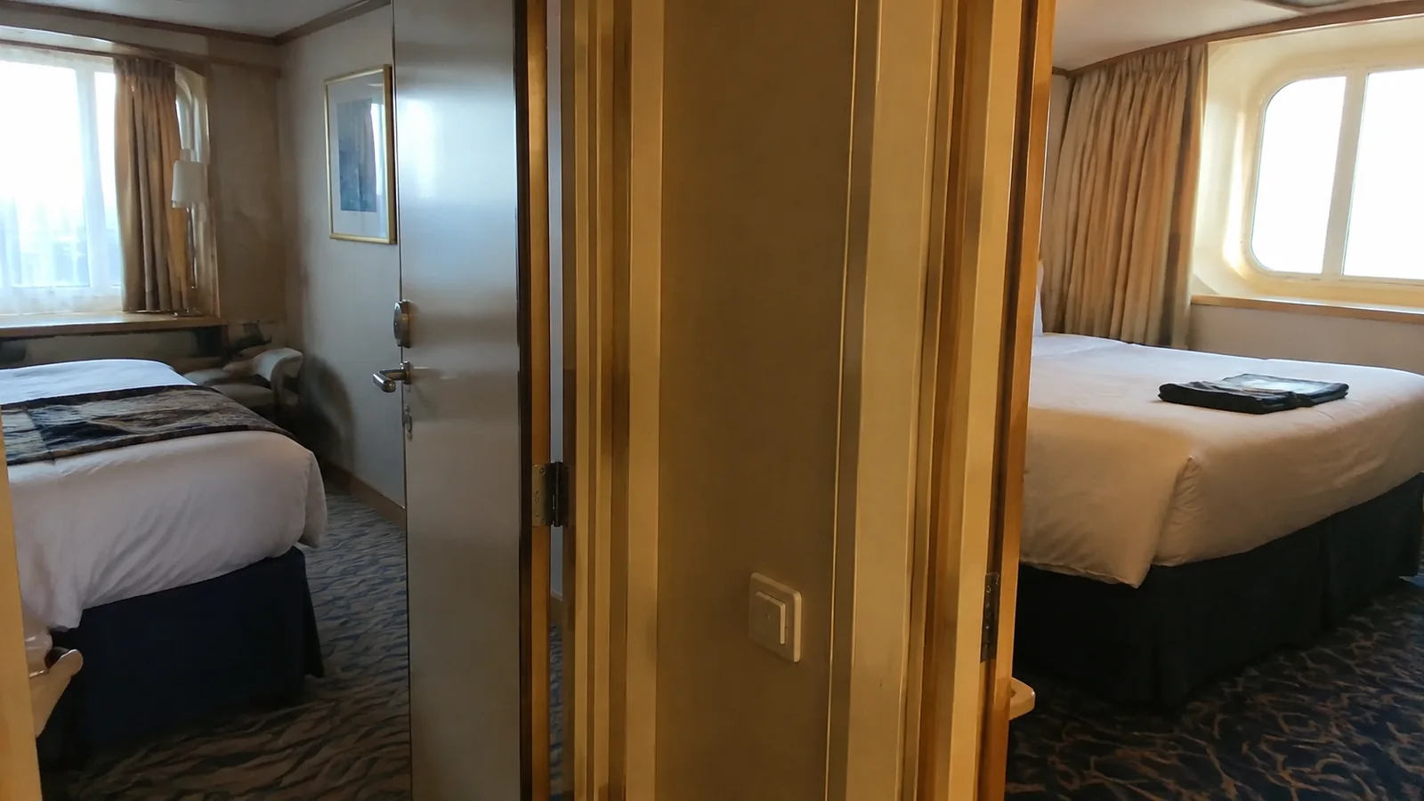 Open connecting doorway between two cruise cabins.