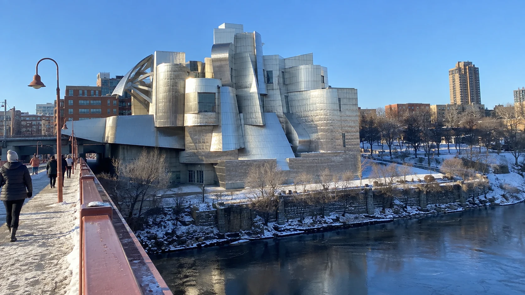 The curving stainless-steel exterior of the Weisman Art Museum beside the river.