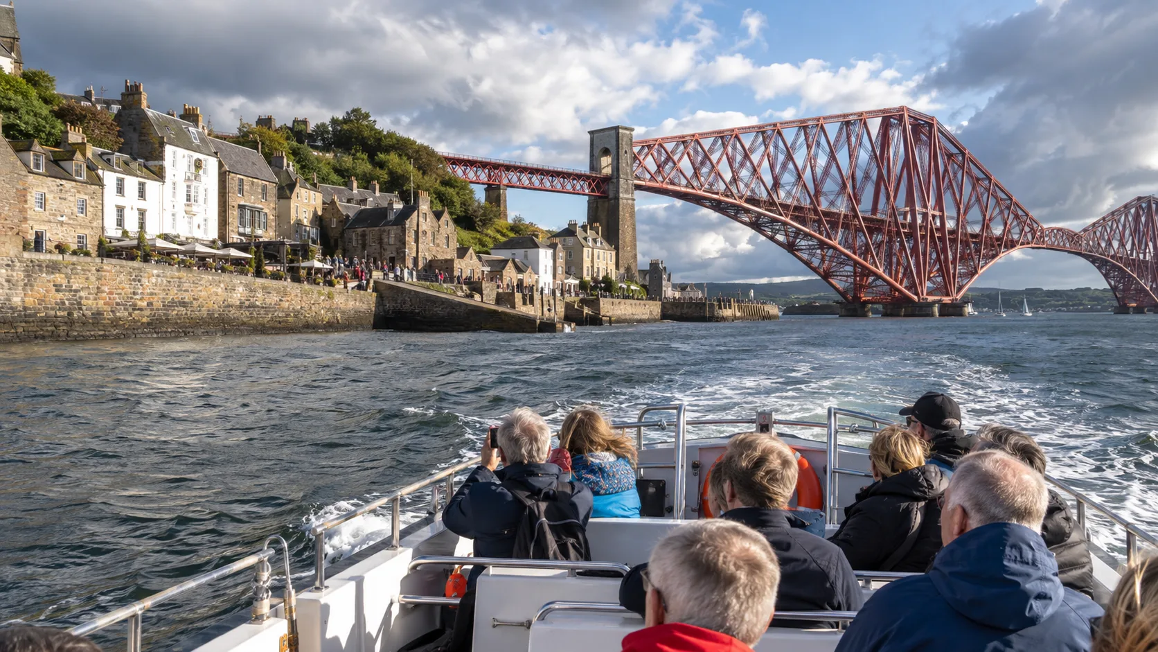 Cruise tender approaching South Queensferry beneath the Forth Bridge near Edinburgh