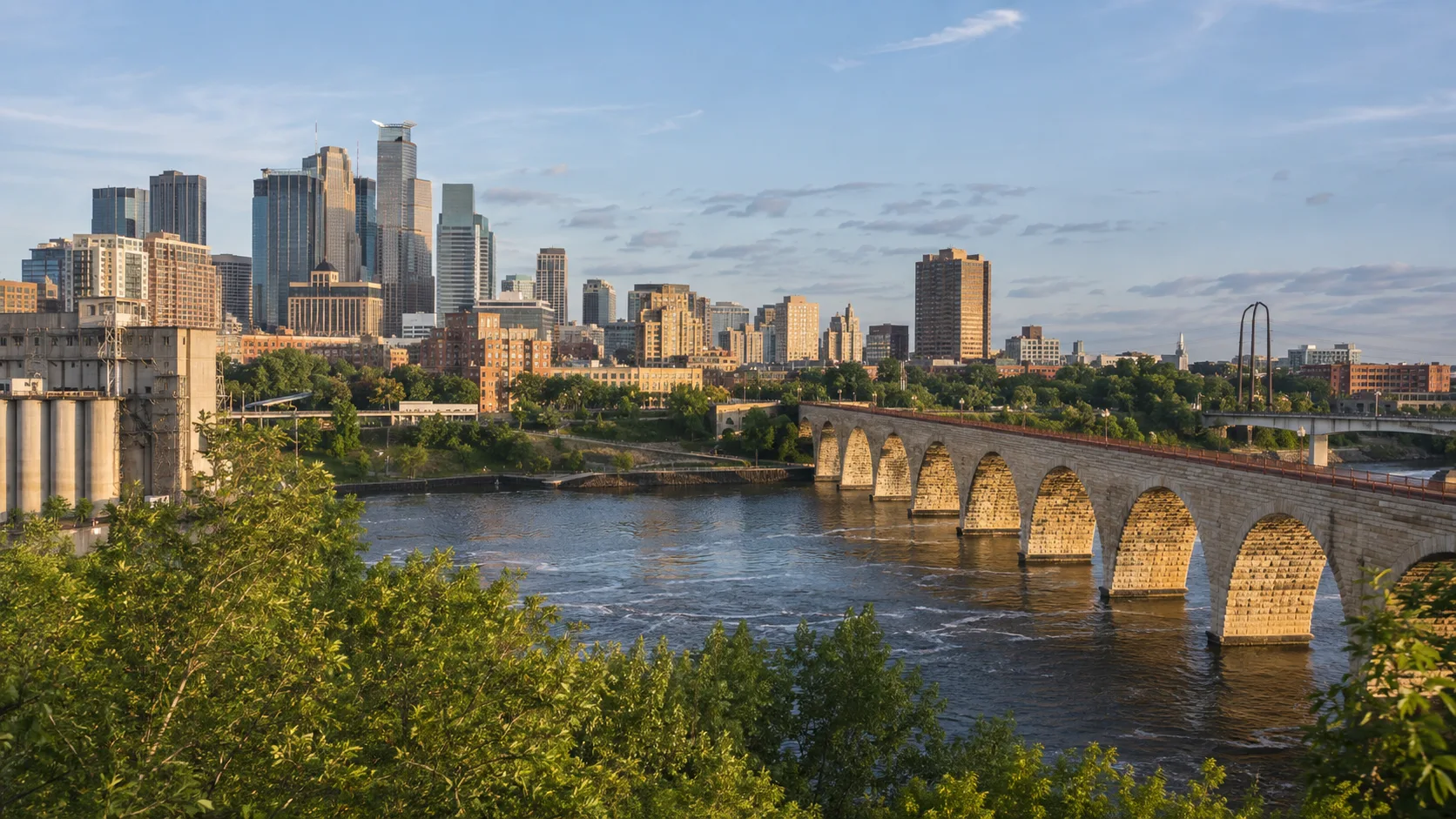 Minneapolis skyline and Stone Arch Bridge above the Mississippi River.