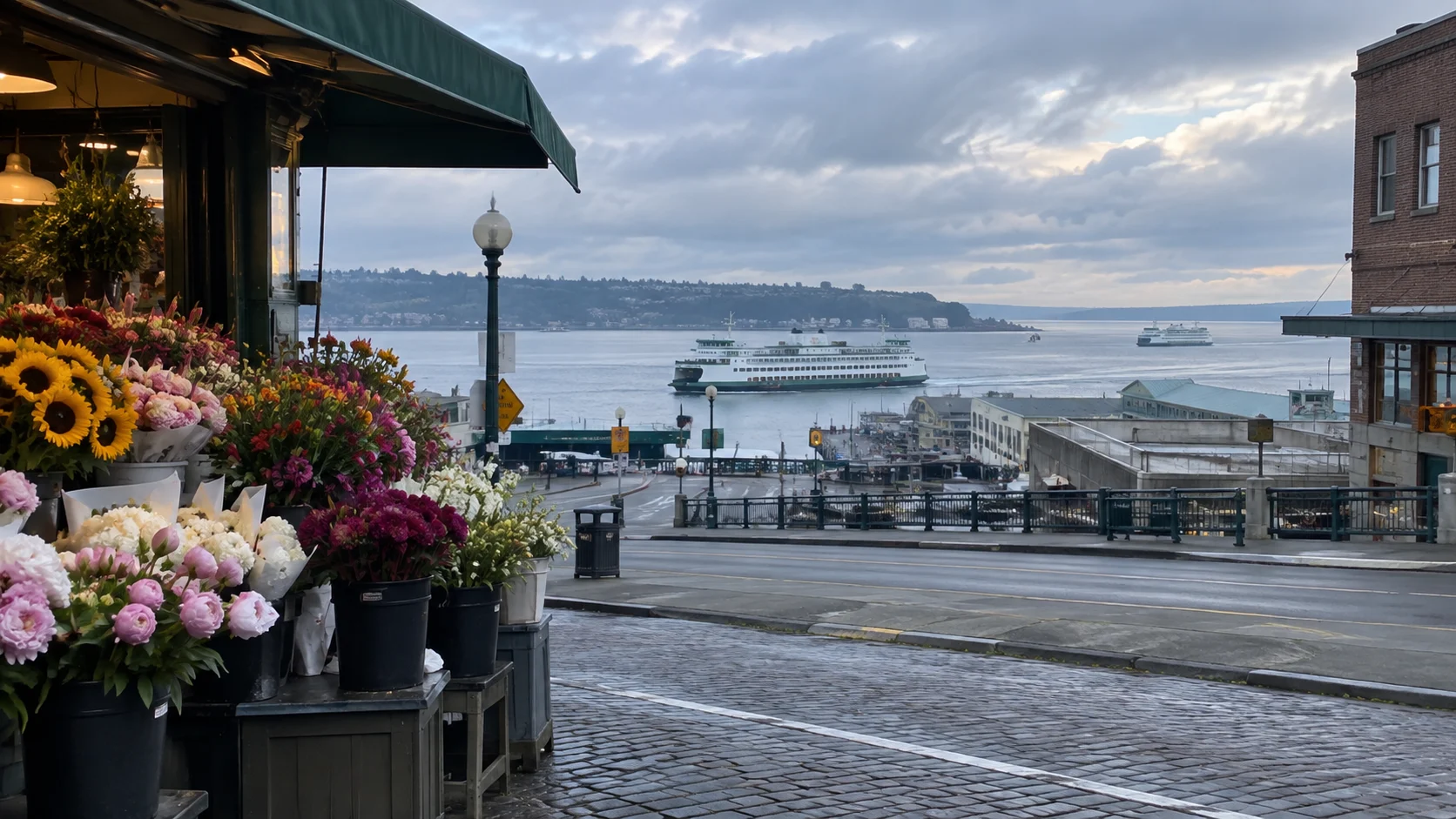 Colorful flowers above Elliott Bay and passing ferries near Pike Place Market in Seattle.