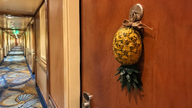 Upside-down pineapple decoration hanging on a cruise cabin door
