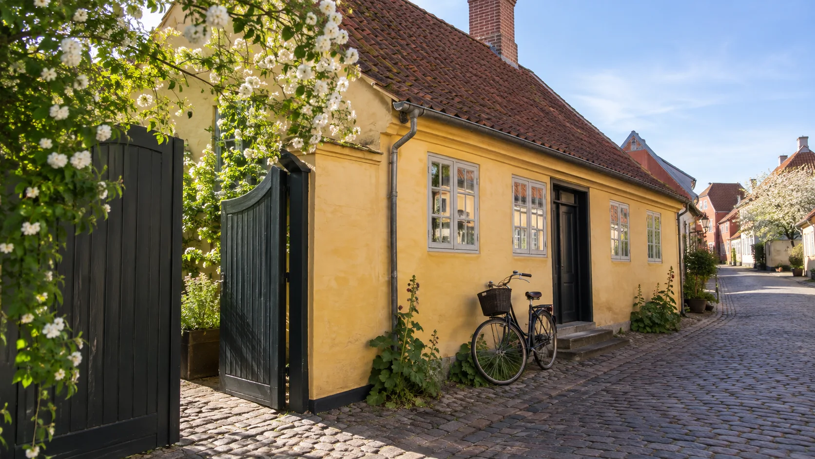 Hans Christian Andersen's yellow childhood home on a cobbled Odense street